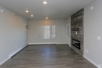 the living room with a fireplace in a bedroom plus den unit. at Mezzo Apartments, Fargo, ND